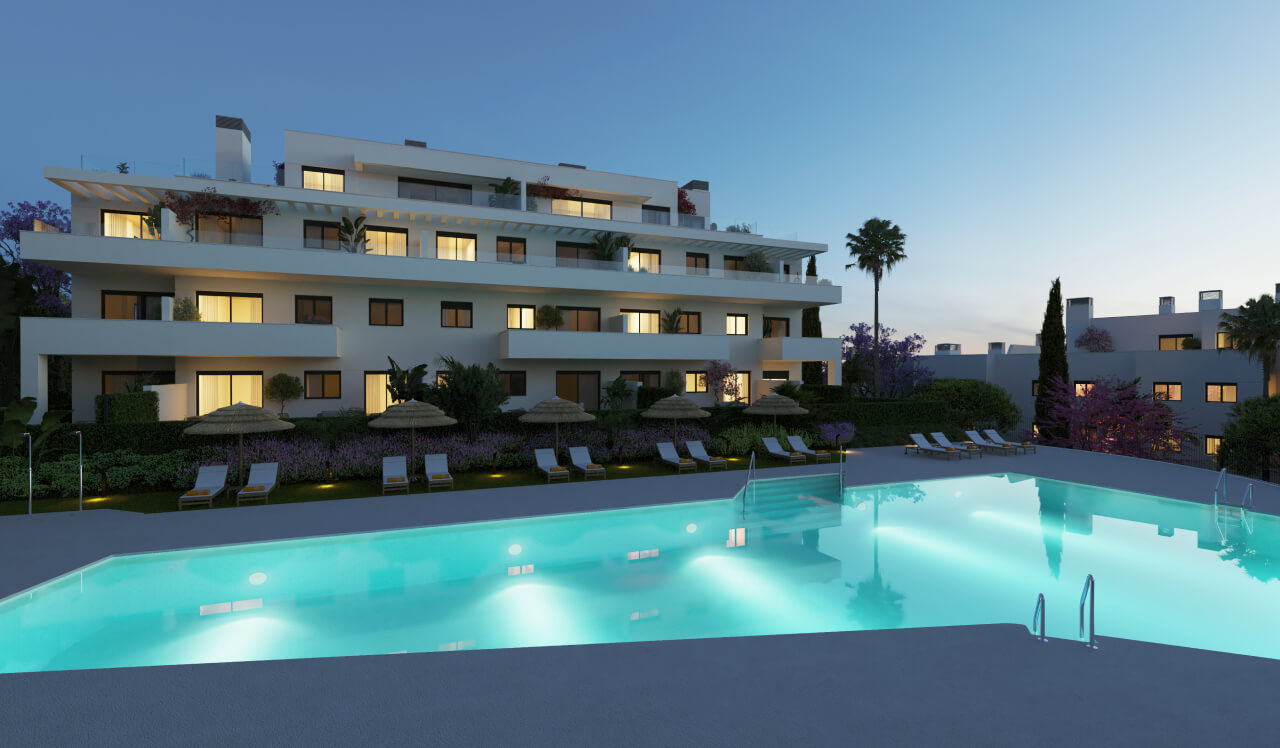 Piscina iluminada y fachada nocturna del residencial Célere Nayra