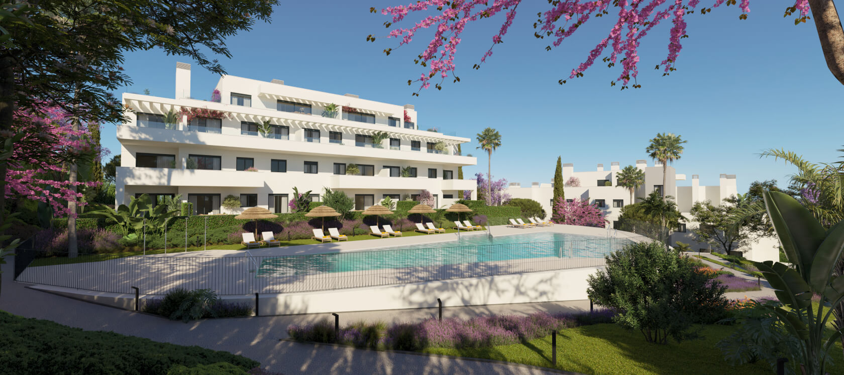 Fachada blanca del residencial Célere Nayra con piscina exterior, jardines y sombrillas en Mijas Costa