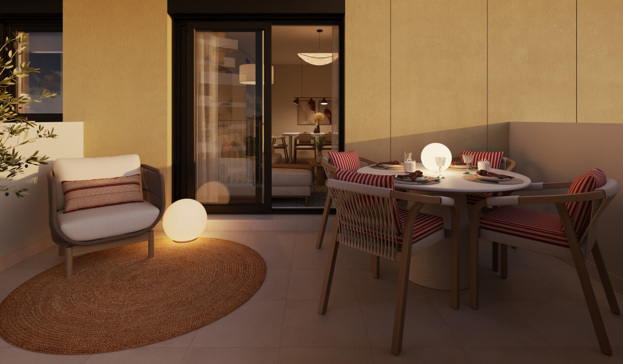 Terraza de una vivienda de obra nueva Vía Célere Jara, equipada con zona de comedor exterior, sillón de descanso, iluminación ambiental y acceso directo al salón mediante puertas acristaladas.