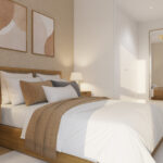 Dormitorio principal de una vivienda de obra nueva Vía Célere Jara, con cama de matrimonio, armarios empotrados, decoración en tonos cálidos y luz natural.