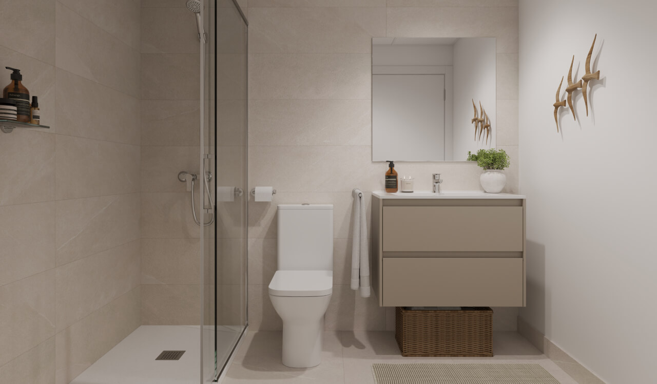 Baño moderno de una vivienda de obra nueva Vía Célere Jara con plato de ducha, mampara de cristal, mueble lavabo suspendido, espejo de gran formato y acabados en tonos neutros.