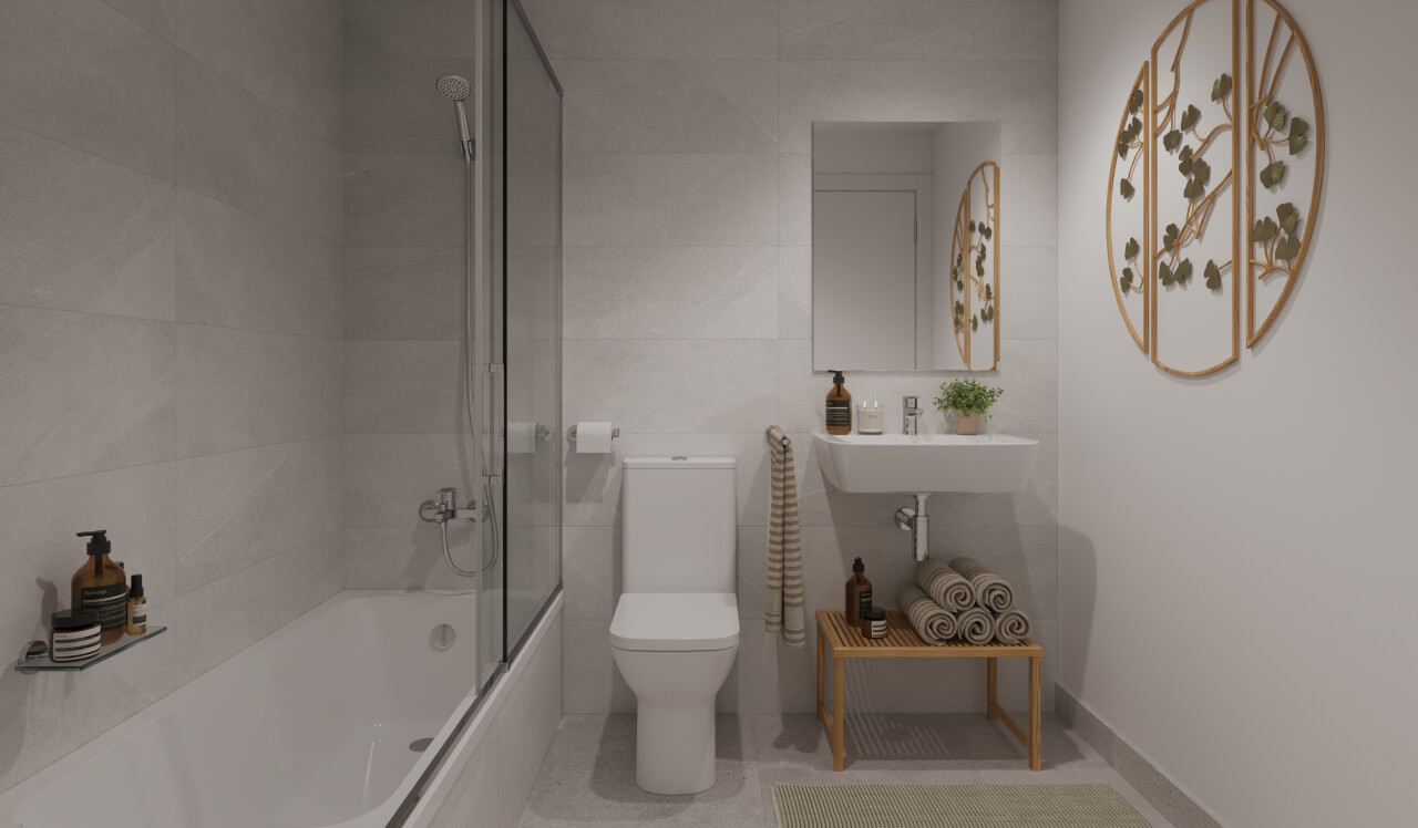 Baño de diseño contemporáneo en la promoción de obra nueva Vía Célere Jara, con bañera, mampara de cristal, lavabo suspendido, espejo decorativo y acabados en tonos neutros.