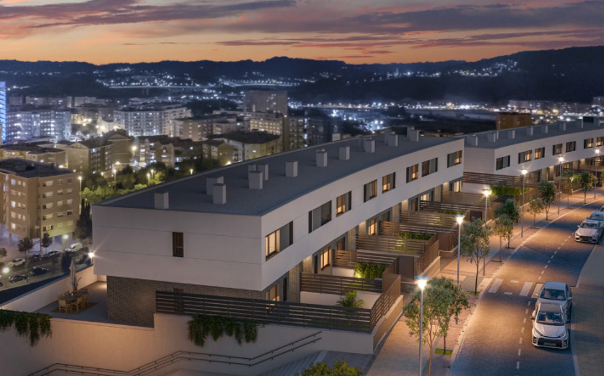 Vista nocturna de chalets unifamiliares de la promoción Célere Cruces IV con iluminación urbana