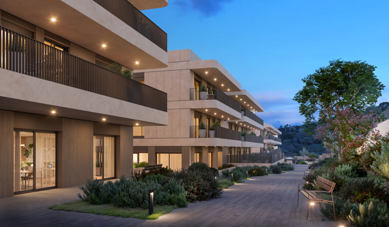 Zona residencial ajardinada de Célere Dalt Mar II al atardecer