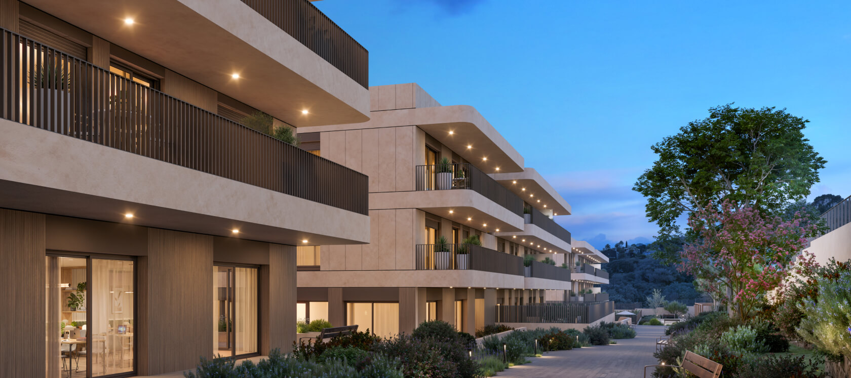 Zona residencial ajardinada de Célere Dalt Mar II al atardecer